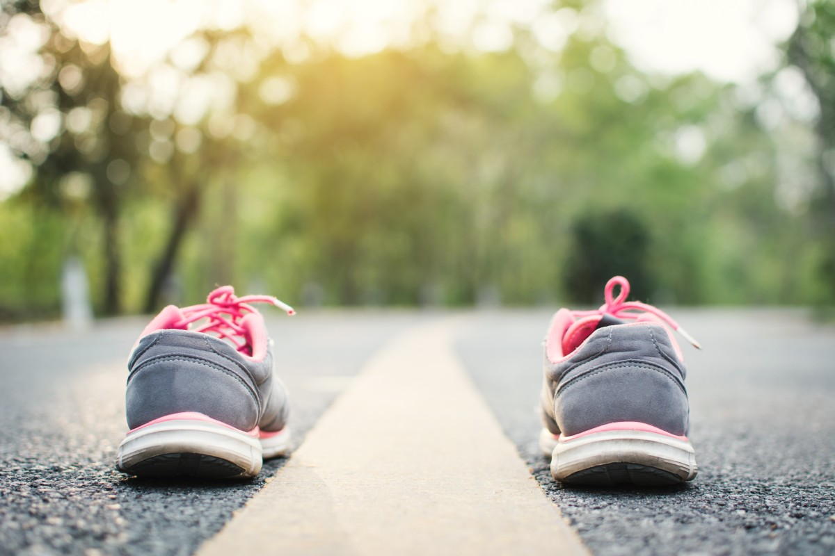 Running shoes, empty, lined up on road line ready..