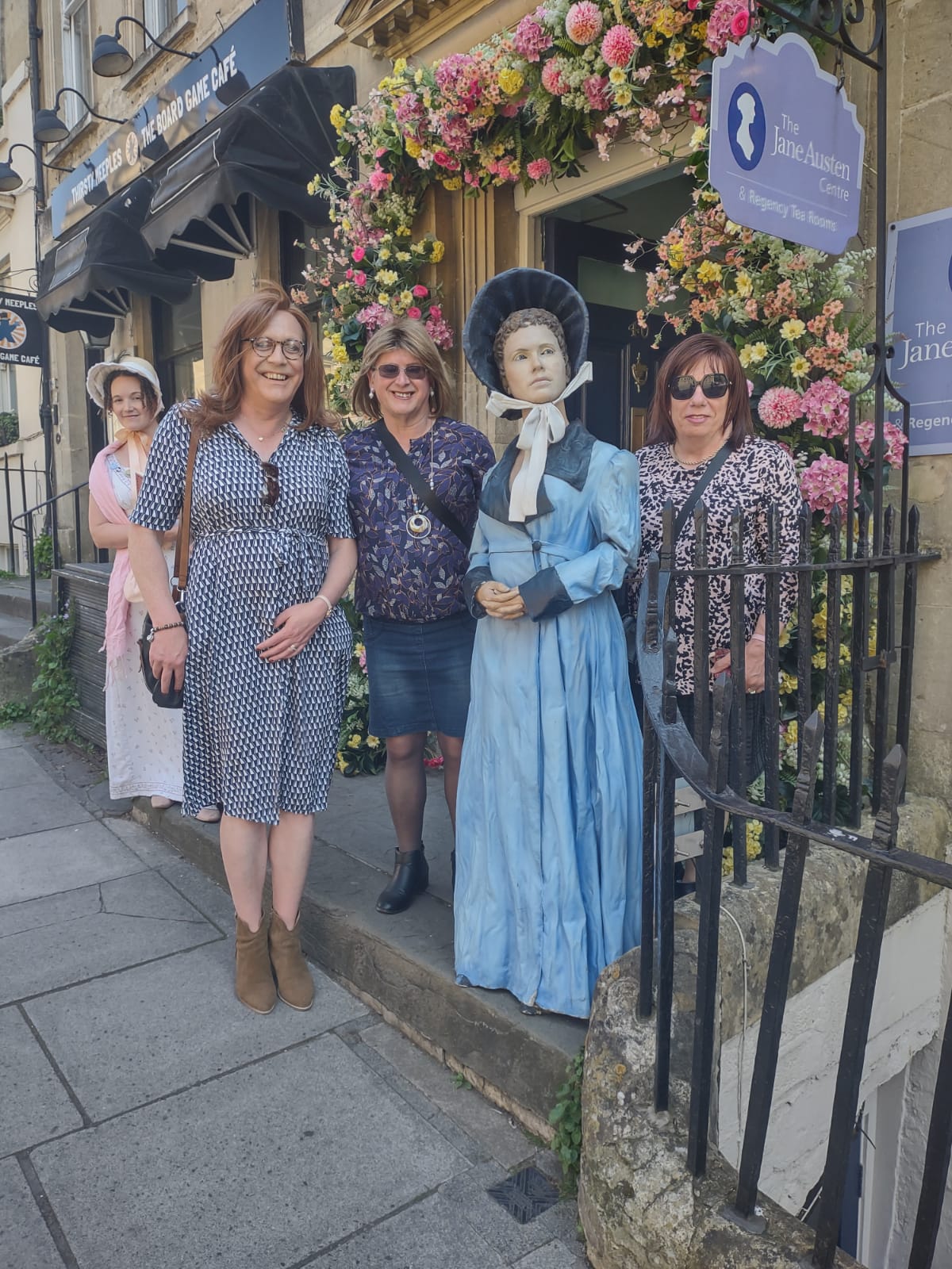 Beaumont members are out shopping, standing next to a mankin in Bath